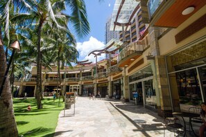 Stunning atrium with lush palm trees, seating areas, and balconies overlooking a beautifully patterned floor.