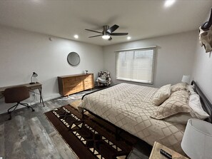Relax in this stylish bedroom with a comfortable bed, bedside table, and dresser.