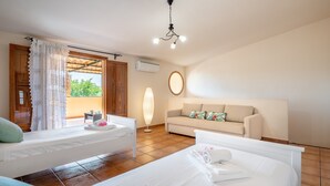A bedroom with two beds, a sofa, a ceiling light, and a window with curtains. - Holiday Home Villa Ca Na Campins with Mountain View, Pool, Terraces & Wi-Fi (Campanet)