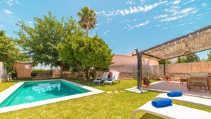A backyard with a swimming pool, lounge chairs, a pergola, and a small shed. - Holiday Home Villa Ca Na Campins with Mountain View, Pool, Terraces & Wi-Fi (Campanet)