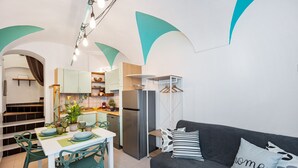Eine moderne Küche mit Essbereich, einer Sitzecke und einer Treppe.
