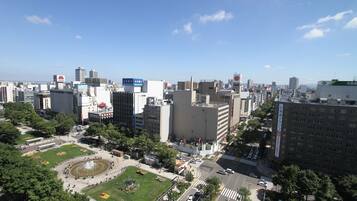 A cityscape with a large public square, modern buildings, and a clear sky.