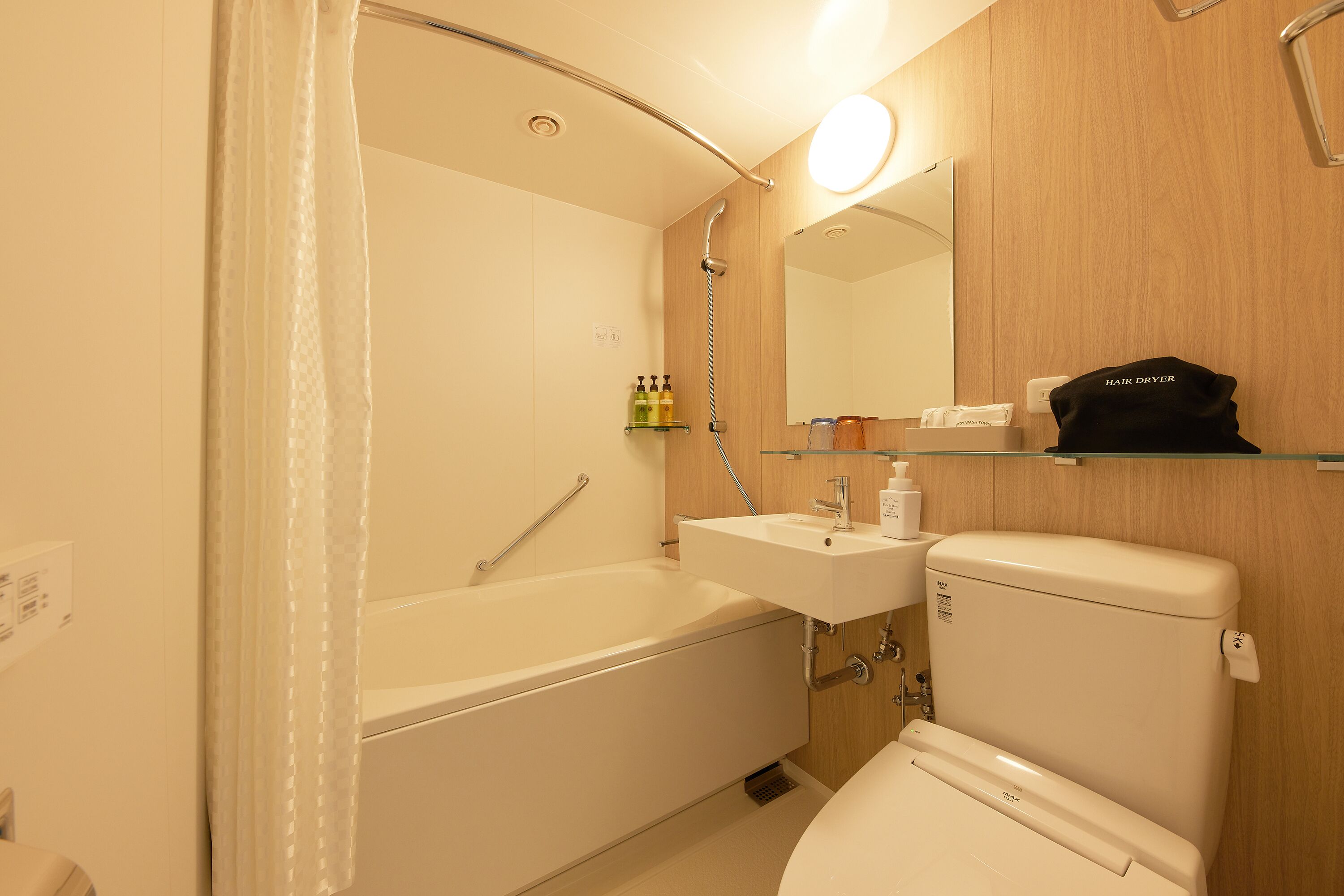 A modern bathroom with a bathtub, a toilet, and a sink.