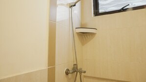 A shower with a handheld showerhead and a wall-mounted faucet. - Comfort 1Br With Working Room At Meikarta Apartment (Cikarang)
