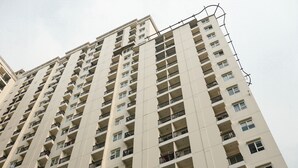 A high-rise building with multiple balconies and windows.