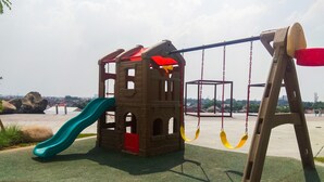 A playground with a slide, swings, and a climbing structure.