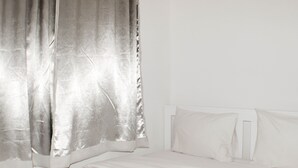 A room with a bed, white curtains, and a white headboard. - Nice And Spacious 3Br At Meikarta Apartment (Cikarang)