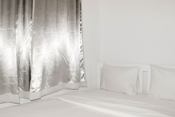 A room with a bed, white curtains, and a white headboard. - Nice And Spacious 3Br At Meikarta Apartment (Cikarang)