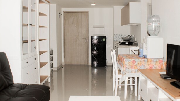A compact living space with a kitchenette, a dining area, and a seating area. - Nice And Spacious 3Br At Meikarta Apartment (Cikarang)