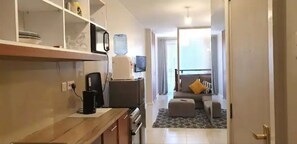Deluxe Studio | Living area | 14-inch Smart TV with cable channels, TV - Stay.Plus Kiambu Road Apartments (Kiambu)