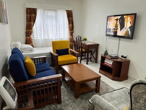 Comfort Apartment | Living area | 14-inch Smart TV with digital channels, TV - Stay.Plus Lantana Road Apartment (Nairobi)