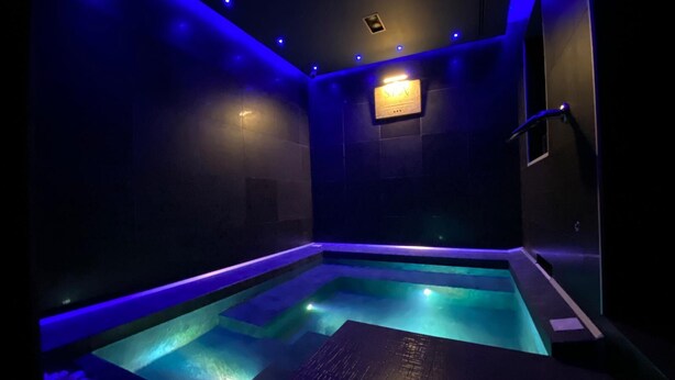 A modern spa area with a heated pool and blue ambient lighting. - Residenze Romano & SPA hotel diff. RED (Foggia)