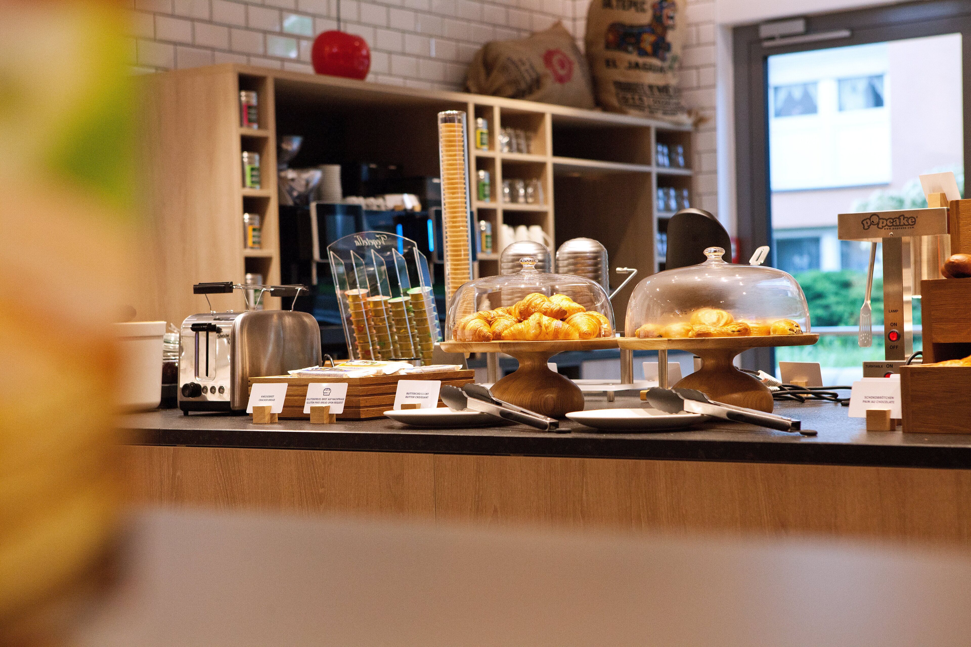 A bakery counter with various baked goods and kitchen equipment.