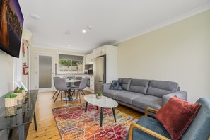 Executive Apartment | Living area | 50-inch flat-screen TV with digital channels, TV