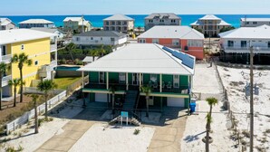 A beachfront property with a pool, multiple buildings, and a clear view of the ocean. - Just a short walk to beach access, Sleeps 12 (Navarre)
