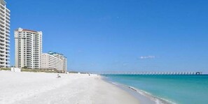 A beach with a long pier extending into the ocean, surrounded by high-rise buildings. - Just a short walk to beach access, Sleeps 12 (Navarre)