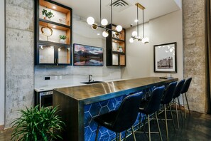 Enjoy cooking and socializing in this kitchen with a central island, sink, and bar seating.