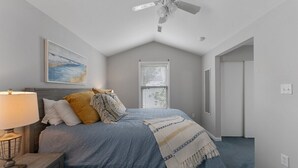 A bedroom with a bed, a ceiling fan, a window with blinds, and a painting on the wall. - Newly Redecorated Beach Home in Wildwood Crest (Wildwood Crest)