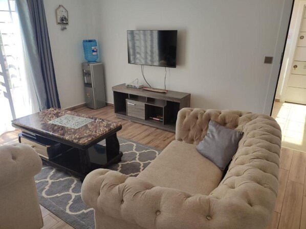 Departamento, 2 habitaciones | Área de sala de estar | Televisión de pantalla plana de 32 pulgadas con canales digitales