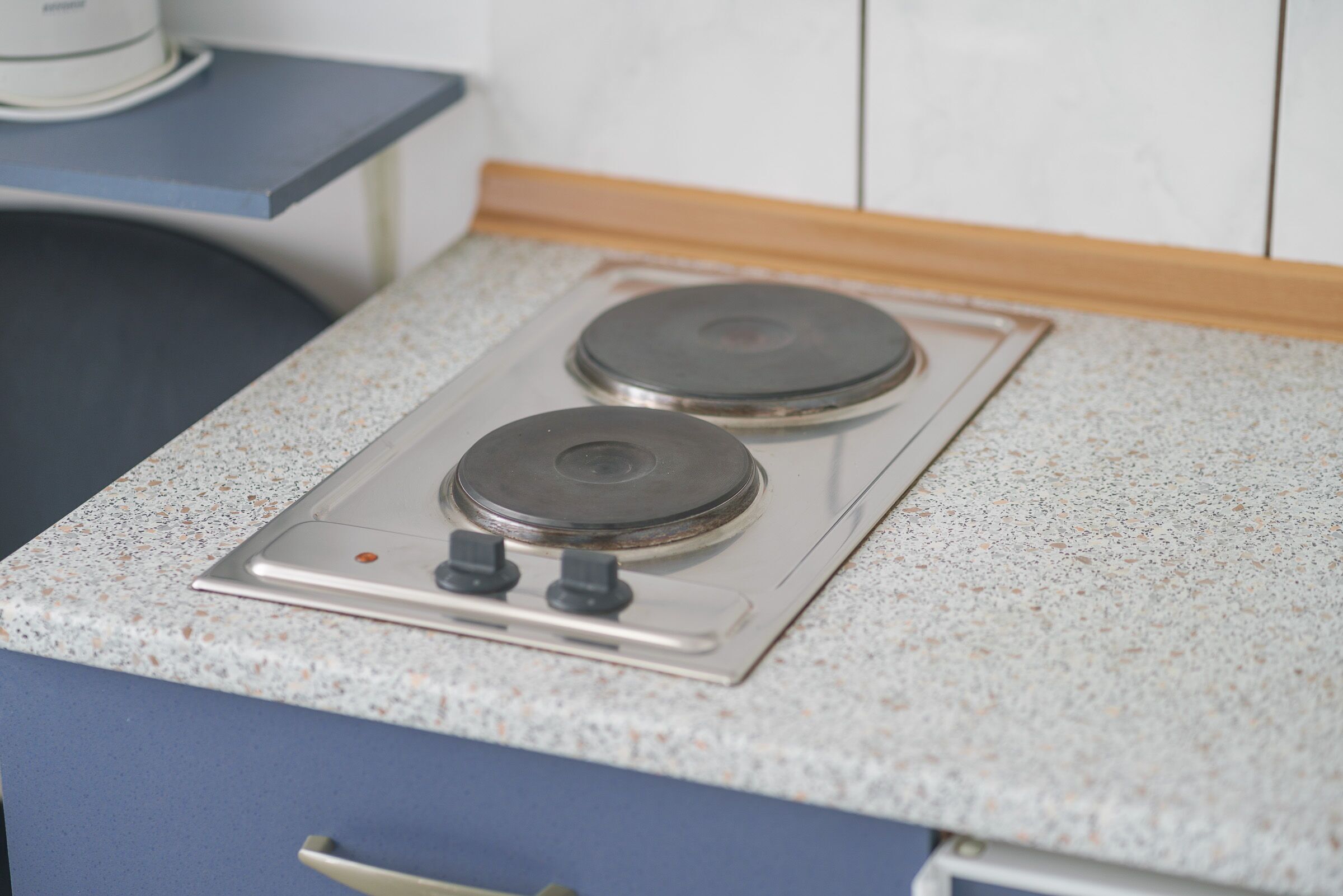 A kitchen with a stainless steel stove and a granite countertop.