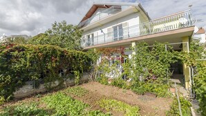 A two-story building with a balcony on the upper floor. - Apartments Bilo (Marina)