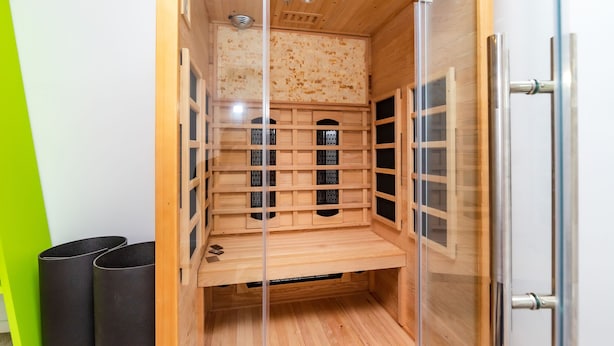 A wooden cabinet with multiple compartments, a metal handle, and a glass door. - House Villa Ivona (Suhovare)