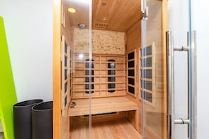A wooden cabinet with multiple compartments, a metal handle, and a glass door.
