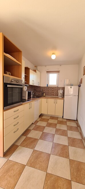 Enjoy cooking in this well-equipped kitchen with an oven, microwave, and refrigerator.