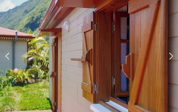 A wooden house with a window and a door.
