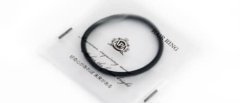 A black hair ring with a white background and text.