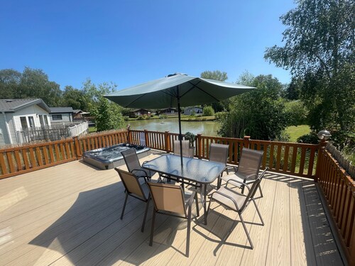 luxury lakeside lodge with a sunken hot tub on bull rush a peaceful feature lake @Tattershall lakes