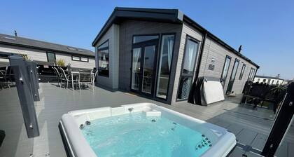 Indulgence Lakeside Lodge i3 is prime location with a private fishing peg and sunken hot tub