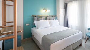 A modern hotel room with a large bed, a desk, and a chair. - Meraki Bozcaada (Bozcaada)