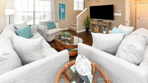 A living room with a sofa set, a coffee table, and a flat-screen TV. - 3BR Walk to the Beach House in Surfside Beach! Looney Dunes (Surfside Beach)