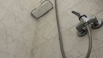 A shower with a handheld showerhead and a flexible hose.