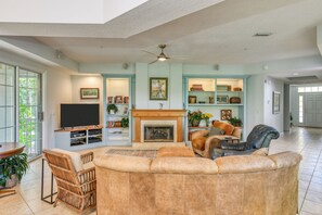 A spacious living room with a fireplace, a television, and a comfortable seating area.
