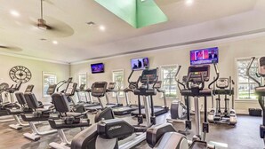 A gym with multiple cardio machines, including treadmills and elliptical trainers, arranged in rows. - 2-BR large private fenced courtyard-close to entrance & pool / hot tub (Saint Augustine)