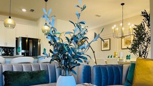 A modern living room with a sofa, a coffee table, and a decorative plant.
