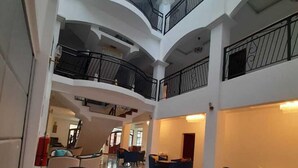 A multi-level atrium with modern furniture and balconies. - L'ver Hotel (Somoto)