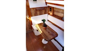 Une cuisine compacte avec des meubles en bois, un petit plan de travail et une plante en pot.