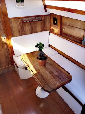 A compact kitchen with wooden cabinetry, a small countertop, and a potted plant.