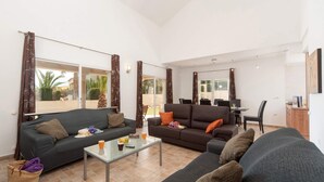 Un saló espaiós amb dos sofàs, una taula de centre i una zona de menjador amb cadires i taula.