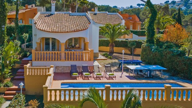 A villa with a swimming pool, outdoor seating, and a view of the surrounding landscape. - Villa Rosa Blanca by Villa Plus (El Tosalet)