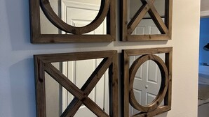 Four wooden-framed mirrors of different shapes mounted on a wall. - Renovated Condo steps from the Beaver Creek shuttle! (Avon)