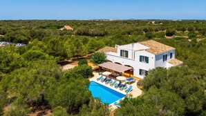 A white villa with a pool and multiple rooms, surrounded by greenery. - Villa Biniparrell by Villa Plus (Biniparrell)