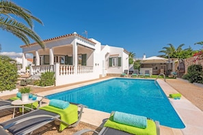 A poolside area with lounge chairs and a swimming pool.
