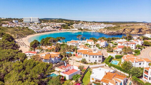 A coastal resort area with villas, a beach, and a marina. - Villa Las Mariposas by Villa Plus (Es Mercadal)