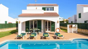 A two-story house with a swimming pool, outdoor seating, and a patio area. - Villa Noa by Villa Plus (Cap d'Artrutx)