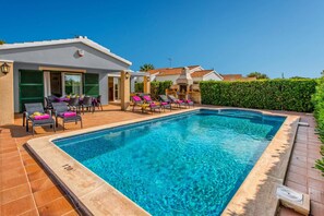 A swimming pool with lounge chairs and a patio area. - Villa Tamarell by Villa Plus (Cap d'Artrutx)