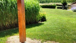 A wooden pergola structure with a tiled patio area.